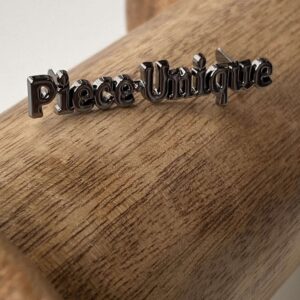 “Piece Unique” writing – Gun Metaal